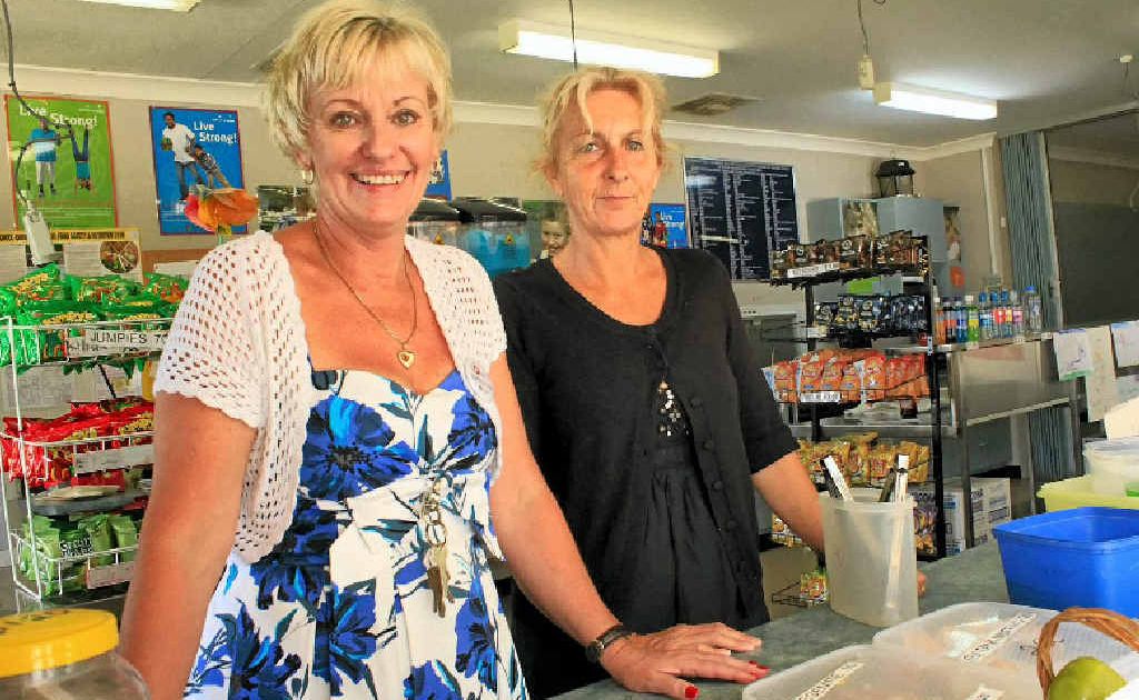 Robynne Yarwood and Diana Williams are kept busy serving behind the tuckshop counter at Warwick West State School.